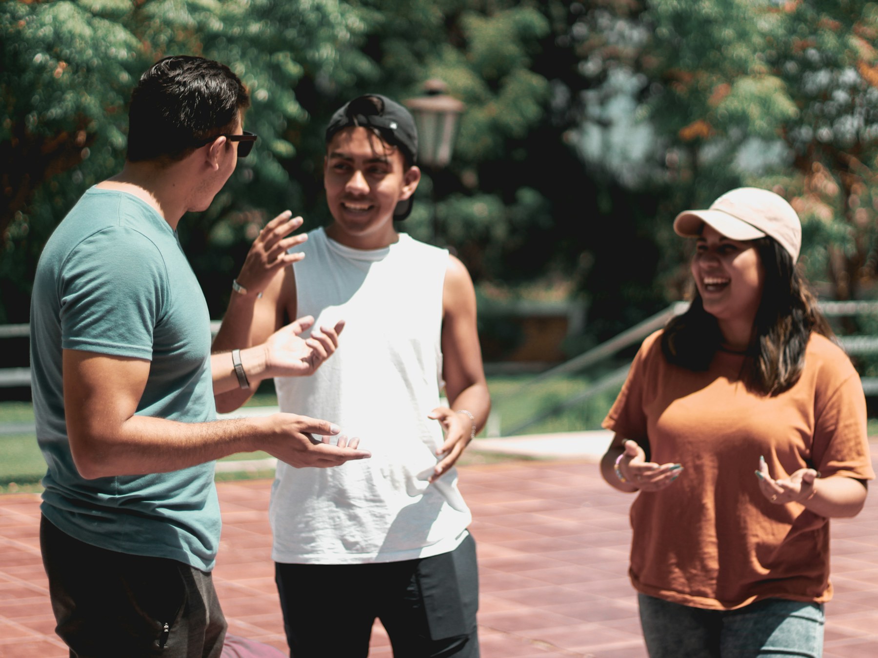 Three people talking together outdoors